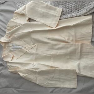 Cream, lightweight woman’s blazer.